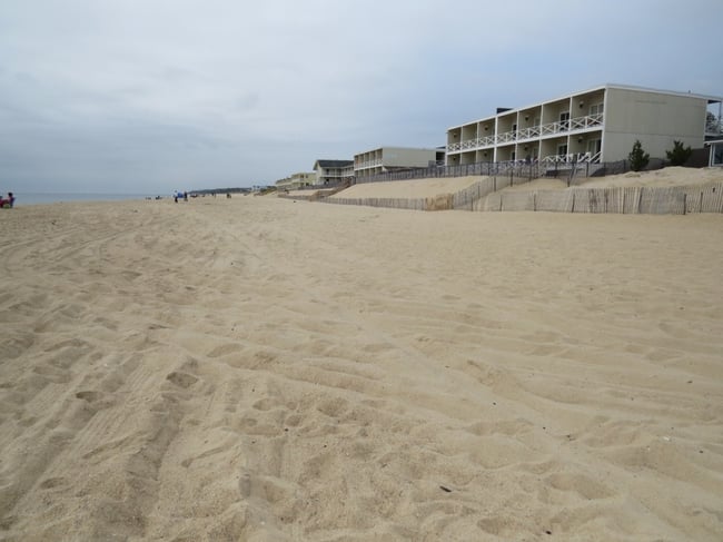 "Spring" high tides reach the snow fencing in front of these motels. The natural dune line would be located where the motels now sit. An artificial dune constructed seaward of these motels would be located in the intertidal zone.